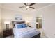 Comfortable bedroom with a ceiling fan, bedside tables with lamps, and an en-suite bathroom at 20170 Benissimo Dr, Venice, FL 34293