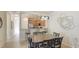 Cozy dining area with modern light fixture, adjacent to the kitchen with breakfast bar at 20170 Benissimo Dr, Venice, FL 34293