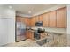 Kitchen featuring stainless steel appliances, granite counters and wooden cabinets at 20170 Benissimo Dr, Venice, FL 34293