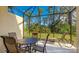 A screened-in lanai, featuring a patio table with seating and a lounge chair, perfect for outdoor relaxation and entertaining at 20170 Benissimo Dr, Venice, FL 34293