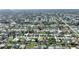 This is an aerial view of a neighborhood with tree lined streets and well maintained homes at 22151 Lancaster Ave, Port Charlotte, FL 33952