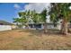 Backyard featuring a large screened in porch and trees providing plenty of shade at 22151 Lancaster Ave, Port Charlotte, FL 33952