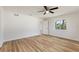 Bright bedroom featuring hardwood floors, a ceiling fan, and a view from the window at 22151 Lancaster Ave, Port Charlotte, FL 33952