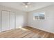 Light-filled bedroom with modern floors, a double closet, ceiling fan, and a bright window at 22151 Lancaster Ave, Port Charlotte, FL 33952