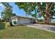 Front exterior of home featuring an attached garage and well maintained lawn at 22151 Lancaster Ave, Port Charlotte, FL 33952