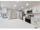 Bright kitchen with stainless steel appliances, white cabinets, granite countertops, and an archway at 22151 Lancaster Ave, Port Charlotte, FL 33952