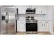 Well-lit kitchen featuring stainless steel appliances, white cabinetry, and light countertops at 22151 Lancaster Ave, Port Charlotte, FL 33952