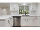 Modern kitchen featuring white cabinets, stainless steel appliances, and a bright window at 22151 Lancaster Ave, Port Charlotte, FL 33952