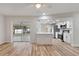 Open concept living space featuring wood floors, a breakfast bar, and modern stainless steel appliances at 22151 Lancaster Ave, Port Charlotte, FL 33952