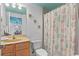 Well-lit bathroom with a vanity, toilet, and shower-tub combo with nautical-themed accents at 224 17Th St # 224, Bradenton Beach, FL 34217