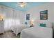 Charming bedroom with two twin beds, crisp white linens, and coastal-themed decor at 224 17Th St # 224, Bradenton Beach, FL 34217