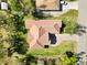 A bird's eye view of a single-Gathering home showcasing the terracotta roof and landscaping at 23117 Hammond Ave, Port Charlotte, FL 33954