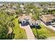 Aerial view of a home features a meticulously manicured yard and a brick driveway, enhancing its curb appeal at 23117 Hammond Ave, Port Charlotte, FL 33954