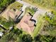 Aerial view of a beautiful home, showcasing its terracotta roof, lush landscaping, and proximity to nature at 23117 Hammond Ave, Port Charlotte, FL 33954