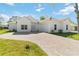 Beautiful single-story home with a red tile roof, brick driveway, and meticulously maintained landscaping at 23117 Hammond Ave, Port Charlotte, FL 33954