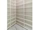 Walk-in pantry with floor-to-ceiling shelving and white marble flooring at 23117 Hammond Ave, Port Charlotte, FL 33954