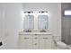 Bright bathroom with double sinks, modern lighting, and a separate toilet area at 2345 Oak Ter, Sarasota, FL 34231