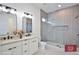 Modern bathroom featuring double sinks, stylish lighting fixtures, and a spacious walk-in shower at 2345 Oak Ter, Sarasota, FL 34231