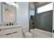 Modern bathroom featuring hexagon tile shower, with a tub and a floating vanity with stone countertop at 2345 Oak Ter, Sarasota, FL 34231