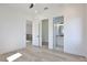 View of bedroom with hardwood floors, doorways, and view to ensuite bathroom at 2345 Oak Ter, Sarasota, FL 34231