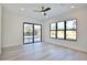 Bedroom showing a sliding glass door to the pool area, large windows, and hardwood floors at 2345 Oak Ter, Sarasota, FL 34231