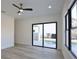 Bedroom showing a sliding glass door to the pool area, large windows, and hardwood floors at 2345 Oak Ter, Sarasota, FL 34231