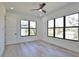 Bright bedroom with large windows, hardwood floors, and modern ceiling fan at 2345 Oak Ter, Sarasota, FL 34231