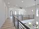 Open hallway with modern railing, hardwood floors, and recessed lighting at 2345 Oak Ter, Sarasota, FL 34231