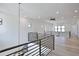 Spacious loft area with hardwood floors, black railings, and abundant natural light at 2345 Oak Ter, Sarasota, FL 34231