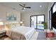 Bedroom showing a sliding glass door to the pool area, decorated bed, and hardwood floors at 2345 Oak Ter, Sarasota, FL 34231