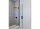 Close-up of shower with glass door and stylish grey tile at 2345 Oak Ter, Sarasota, FL 34231