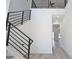 Bright foyer with wood stairs, modern railings, a landing with a fan, and a hallway at 2345 Oak Ter, Sarasota, FL 34231