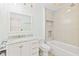 Bathroom with tub, tile surround, and a marble vanity countertop at 2375 Riverwood Pines Dr, Sarasota, FL 34231