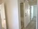 Hallway with open bathroom featuring tile flooring and walk-in shower at 2375 Riverwood Pines Dr, Sarasota, FL 34231