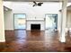 Spacious living room with brick flooring, a white brick fireplace, and sliding glass doors for ample natural light at 2375 Riverwood Pines Dr, Sarasota, FL 34231