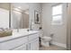 Bright bathroom with a modern white vanity, quartz countertop and neutral decor at 2388 Armenia Rd, North Port, FL 34286