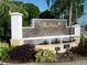 Welcoming sign for The Palms Condominiums with decorative landscaping and a water feature, enhancing the curb appeal at 2755 Coconut Bay Ln 1K # 119, Sarasota, FL 34237