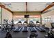 Gym featuring treadmills, ellipticals, and stationary bikes with large windows overlooking a pool at 2755 Coconut Bay Ln 1K # 119, Sarasota, FL 34237