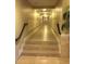 Long hallway with tile flooring, decorative wall trim, and overhead lighting at 2755 Coconut Bay Ln 1K # 119, Sarasota, FL 34237