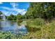 Community pond with water lilies and a fountain, enhancing the scenery for relaxation and natural enjoyment for residents at 2755 Coconut Bay Ln 1K # 119, Sarasota, FL 34237