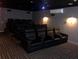 Home theater with plush seating and ambient lighting for an immersive viewing experience at 2755 Coconut Bay Ln 1K # 119, Sarasota, FL 34237