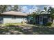 Backyard featuring partial view of the home, greenery, and shade trees at 2784 Martin St, Sarasota, FL 34237