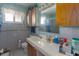 Bathroom with vintage tile, a vanity, and a framed mirror at 2784 Martin St, Sarasota, FL 34237