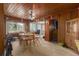 Cozy wood-paneled dining area featuring a ceiling fan and plenty of natural light at 2784 Martin St, Sarasota, FL 34237