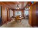 Cozy wood-paneled dining area with a classic table and chairs, showcasing warm ambiance at 2784 Martin St, Sarasota, FL 34237