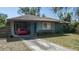 Inviting home showcasing a covered carport and a tidy front yard, presenting a welcoming appearance at 2784 Martin St, Sarasota, FL 34237