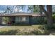 Cozy home featuring a covered carport and a well-manicured lawn, blending comfort and convenience at 2784 Martin St, Sarasota, FL 34237