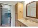 Bathroom featuring glass shower doors, ample cabinet space, and a large vanity at 2961 Taywood Mdws # 26, Sarasota, FL 34235