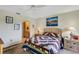 Inviting bedroom with view to ensuite bath and nautical art on the wall at 2961 Taywood Mdws # 26, Sarasota, FL 34235