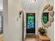 Bright entryway features a decorative mirror and an open door to the outside at 2961 Taywood Mdws # 26, Sarasota, FL 34235